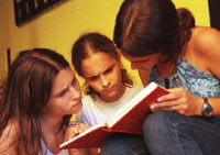 Niñas leyendo un libro.